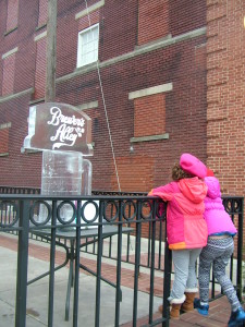 Children inspect an ice sculpture at Brewer's Alley. Photo by Corinne Looper.